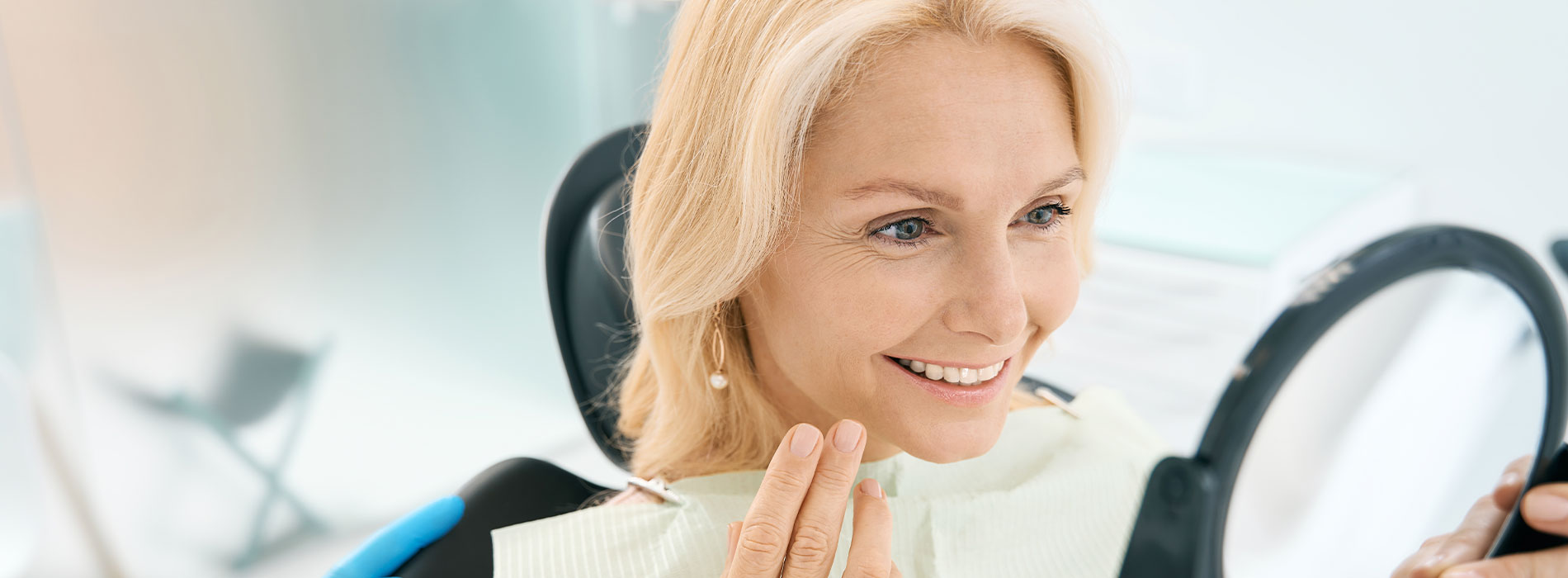 The image shows a modern dental clinic interior with various pieces of equipment, including a dental chair and an X-ray machine.